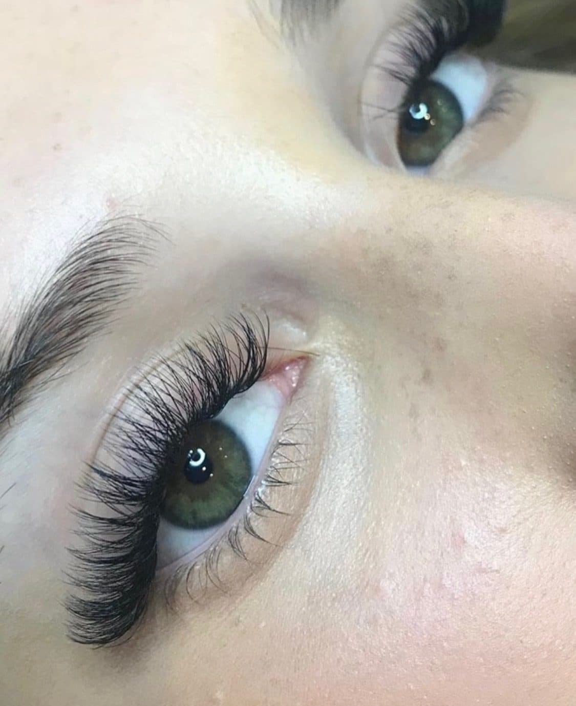 Lash extensions on an open eye, full and dark